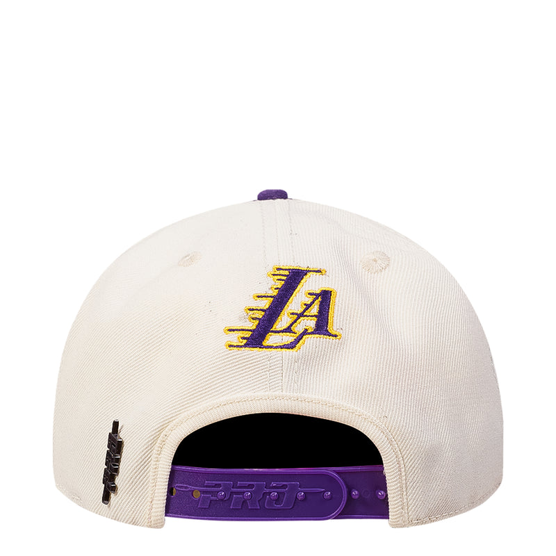 White back panel snapback cap with embroidered LA monogram and purple underside