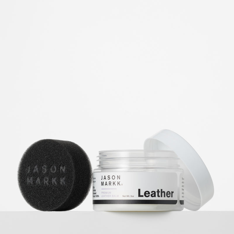 Leather conditioning balm jar with open lid and black sponge applicator pad