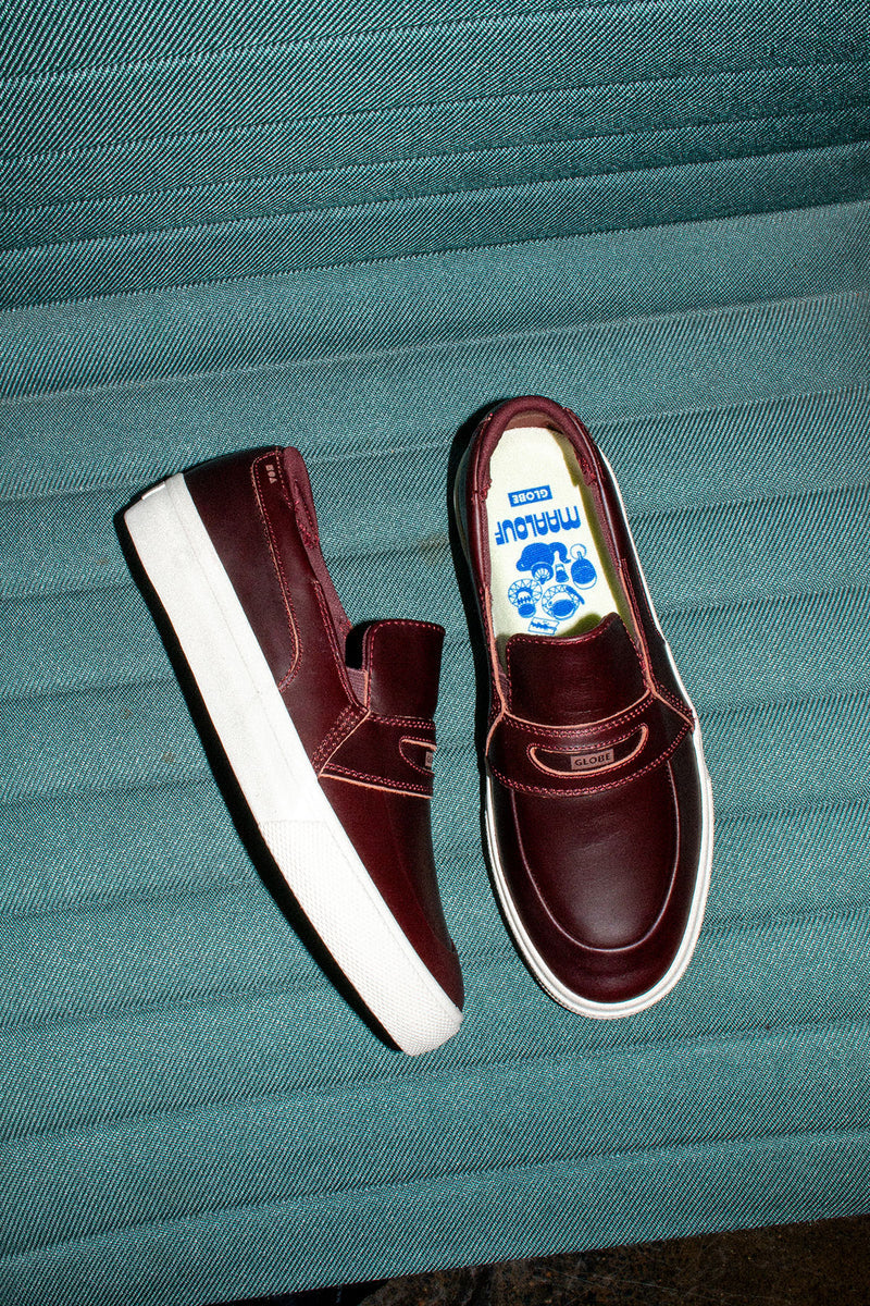 Two oxblood Liaizon shoes on teal denim backdrop viewed from above.