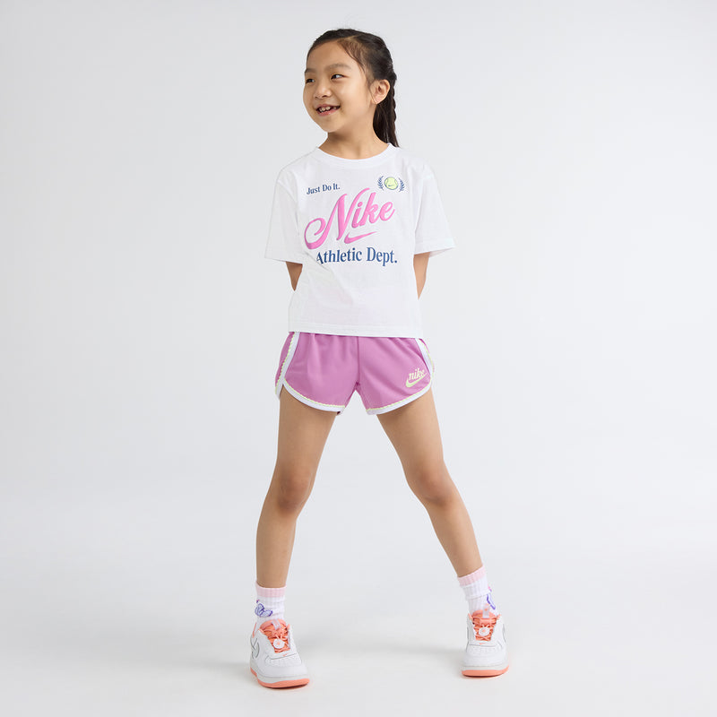 Kids T-shirt and light magenta shorts set with Nike graphics; full-body side view