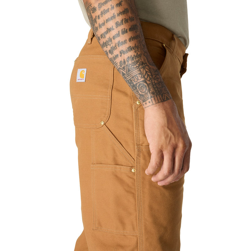 Brown duck dungaree pants side seam close-up with cargo-style pocket and buttons