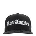 Black baseball cap with white Los Angeles script logo on the front panel