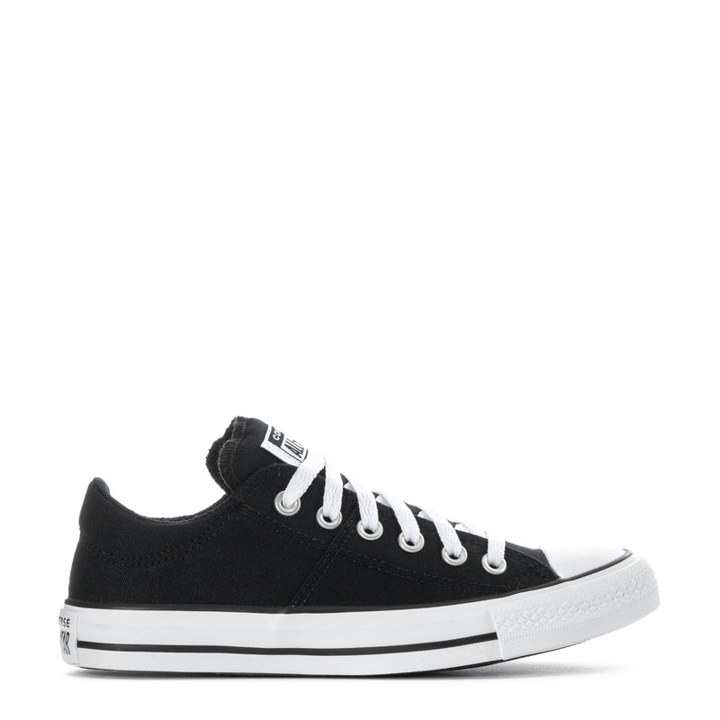 Black low-top canvas sneakers with white laces and white rubber toe cap