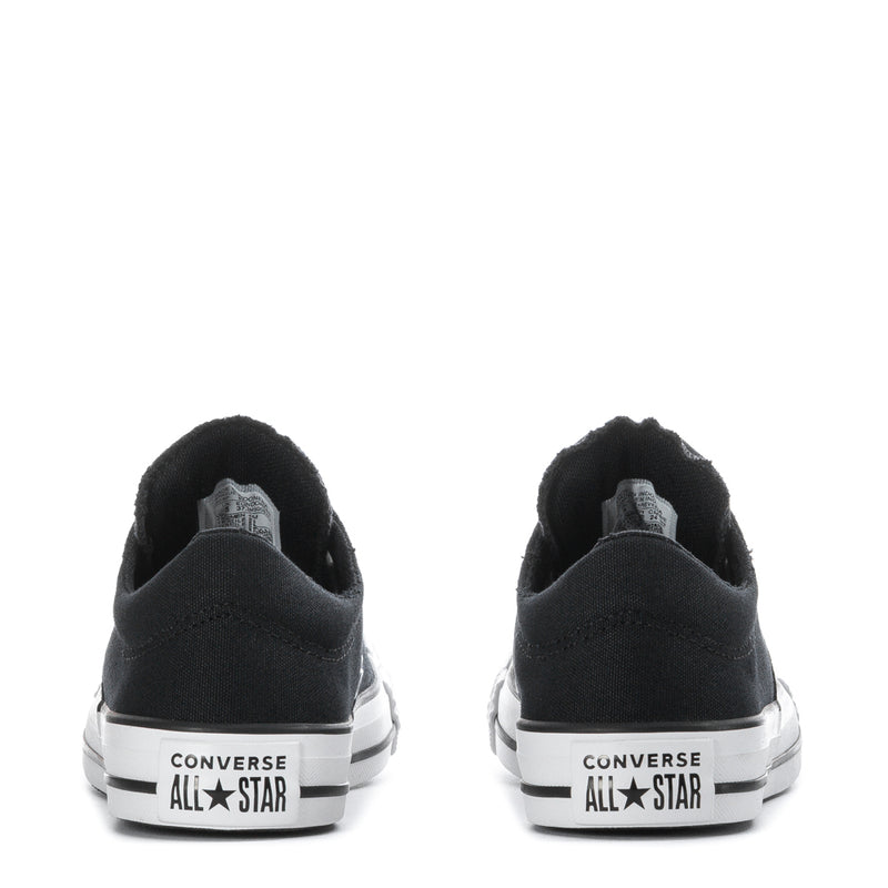 Back view of black low-top sneakers with white “CONVERSE ALL STAR” heel branding