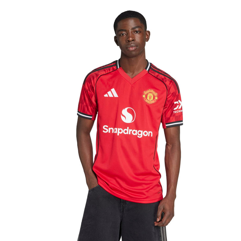 Men's red Manchester United home replica jersey, V-neck with black trim and crest on chest