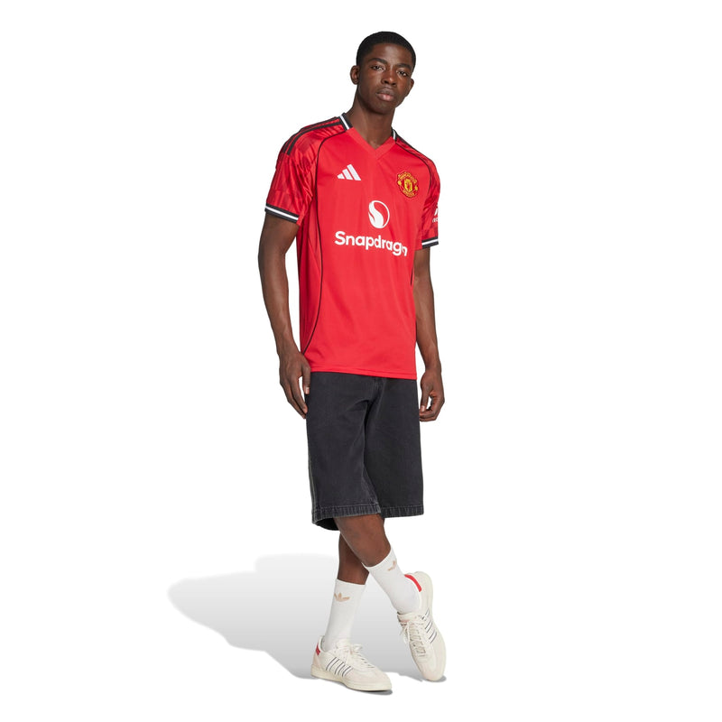 Men's red soccer jersey and black shorts, back-side view with black-trim collar and sleeve cuffs