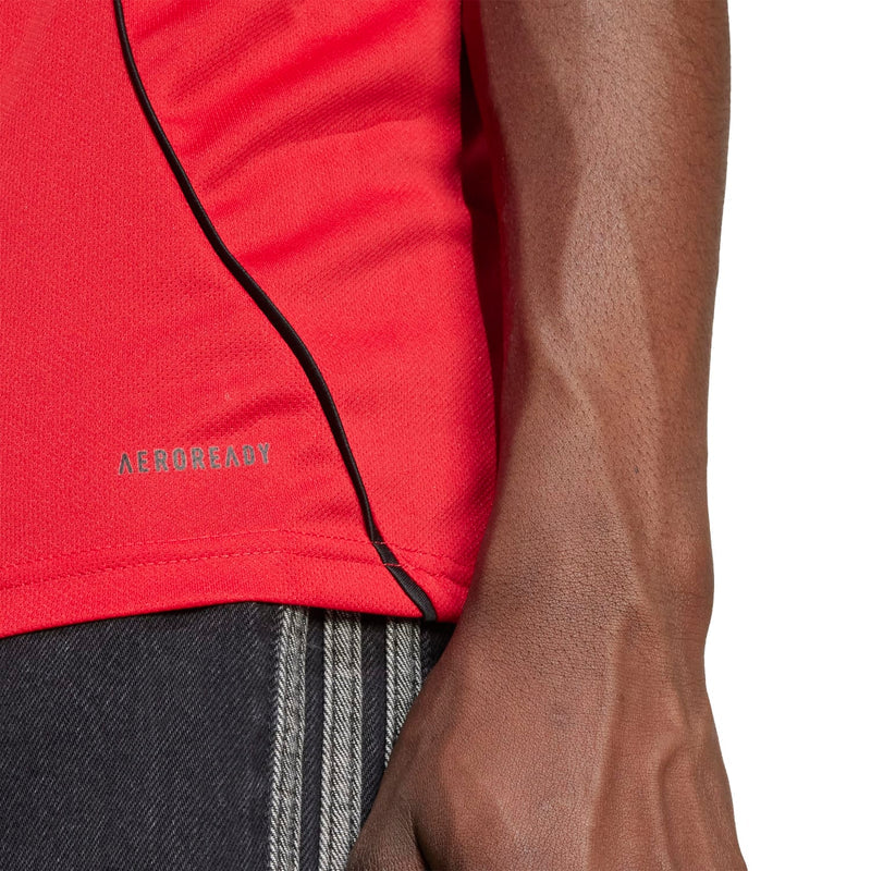 Red jersey fabric detail with black piping seam and AEROREADY text on sleeve