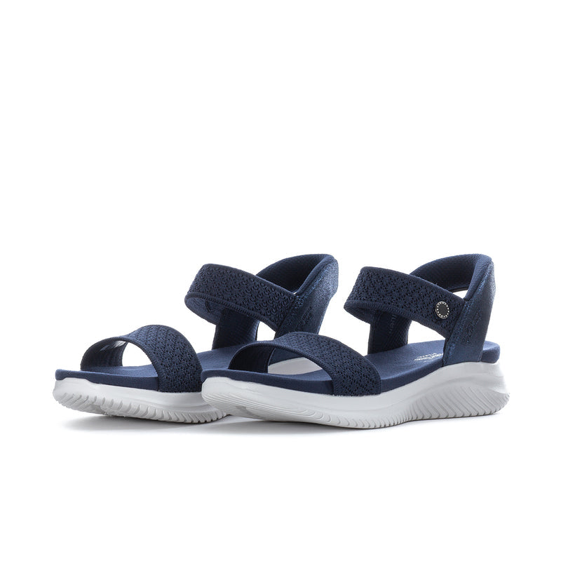 Navy slip-on sandals with wide crisscross straps and white ridged sole