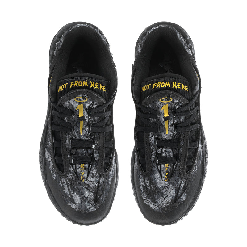 Men's sneakers tongue and lace area with yellow graphic text, dark black upper