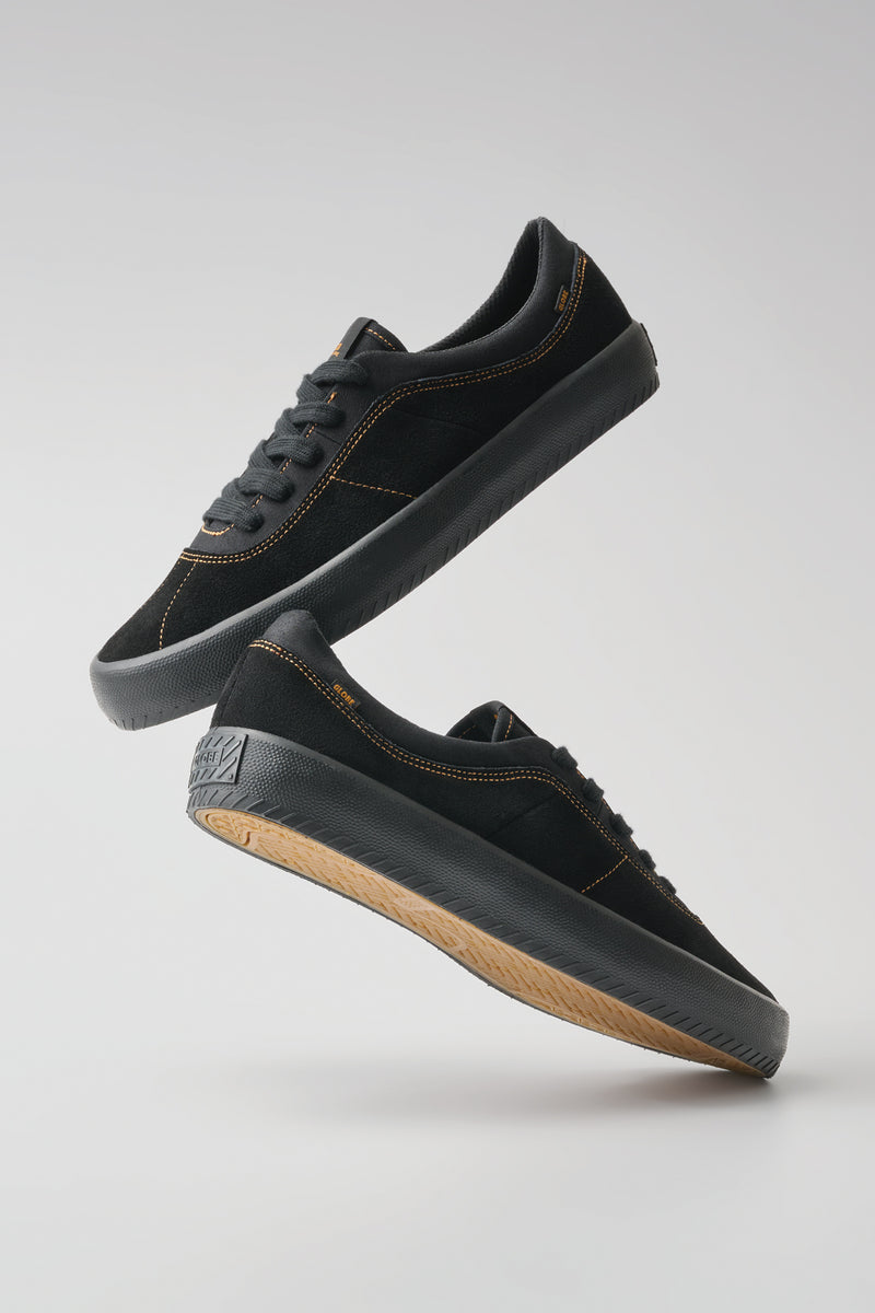 Melbek skate shoe in black suede with orange stitching and black outsole