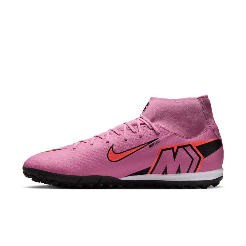 Men's pink turf soccer cleats with black/orange swoosh and bold 'M' graphic