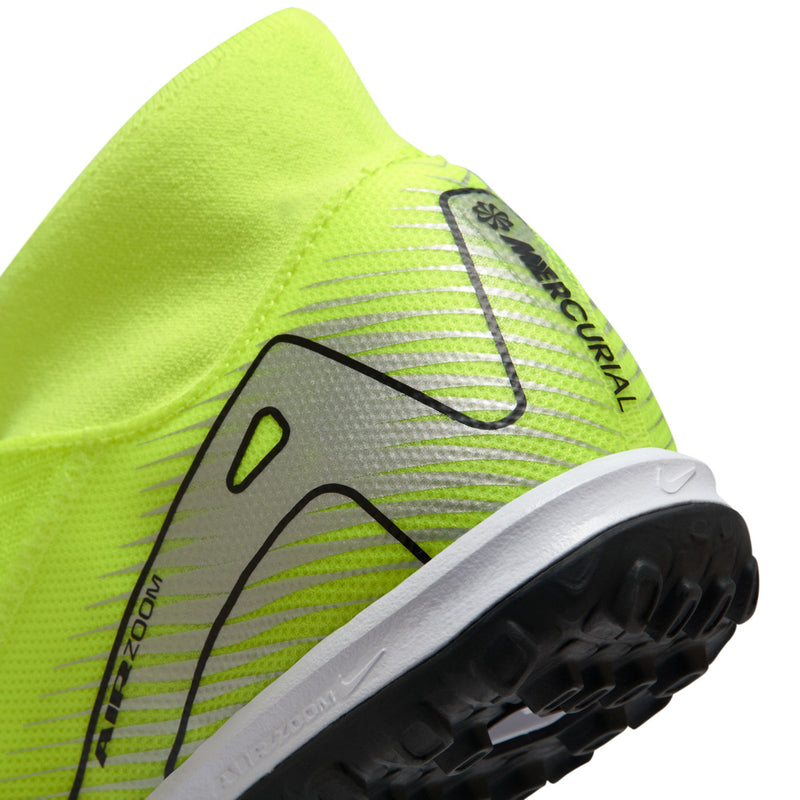 Lateral close-up of neon green turf cleat with black lines and Mercurial branding