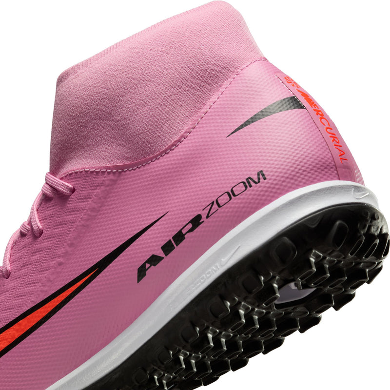 Close-up of men's pink turf soccer cleats with orange edge trim and Air Zoom branding