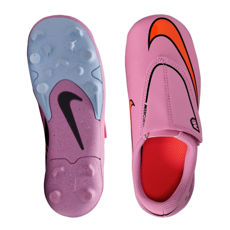 Kids pink soccer cleats pair, showing tread sole and mesh-like upper