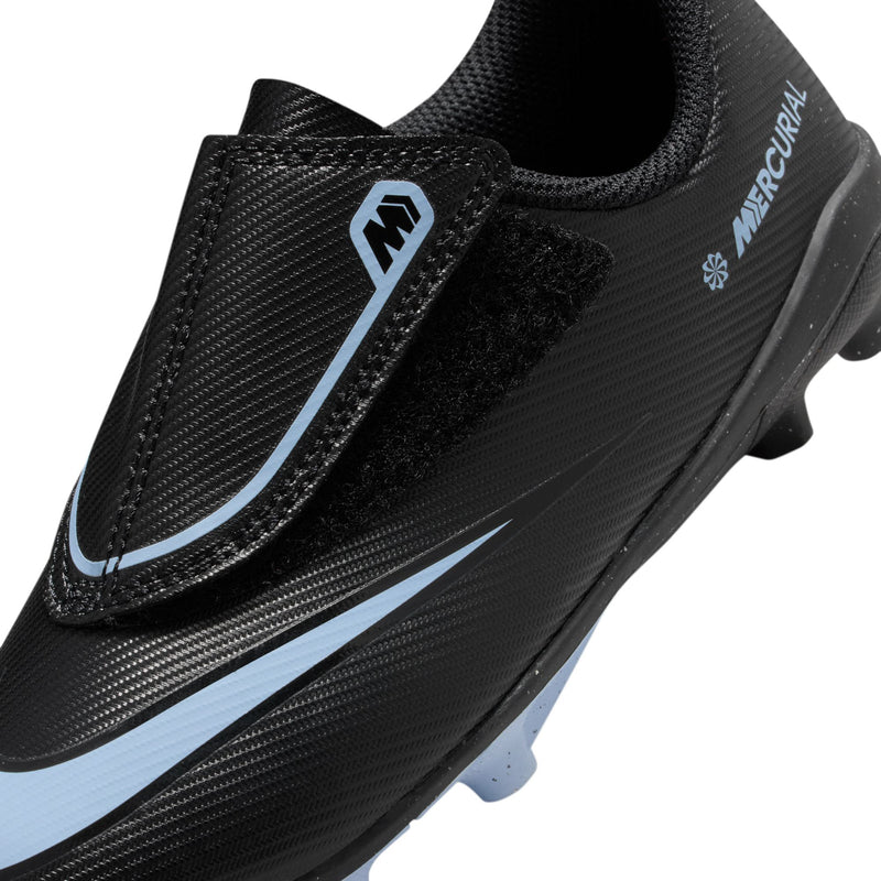 Kids black soccer cleat close-up of side panel, blue swoosh logo, molded studs
