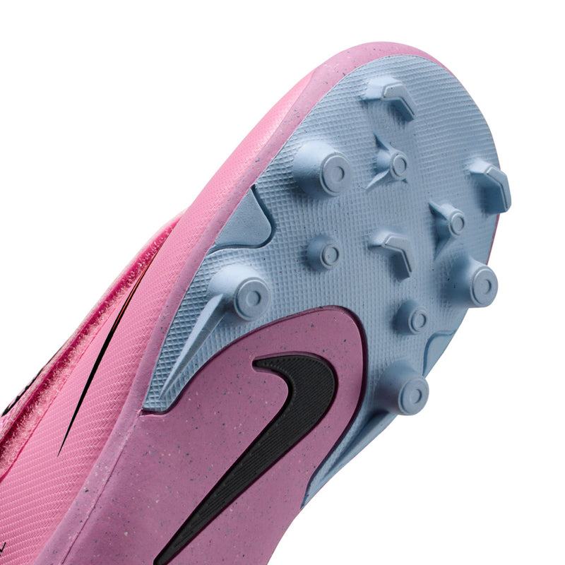 Kids pink soccer cleat outsole close-up with round studs for traction