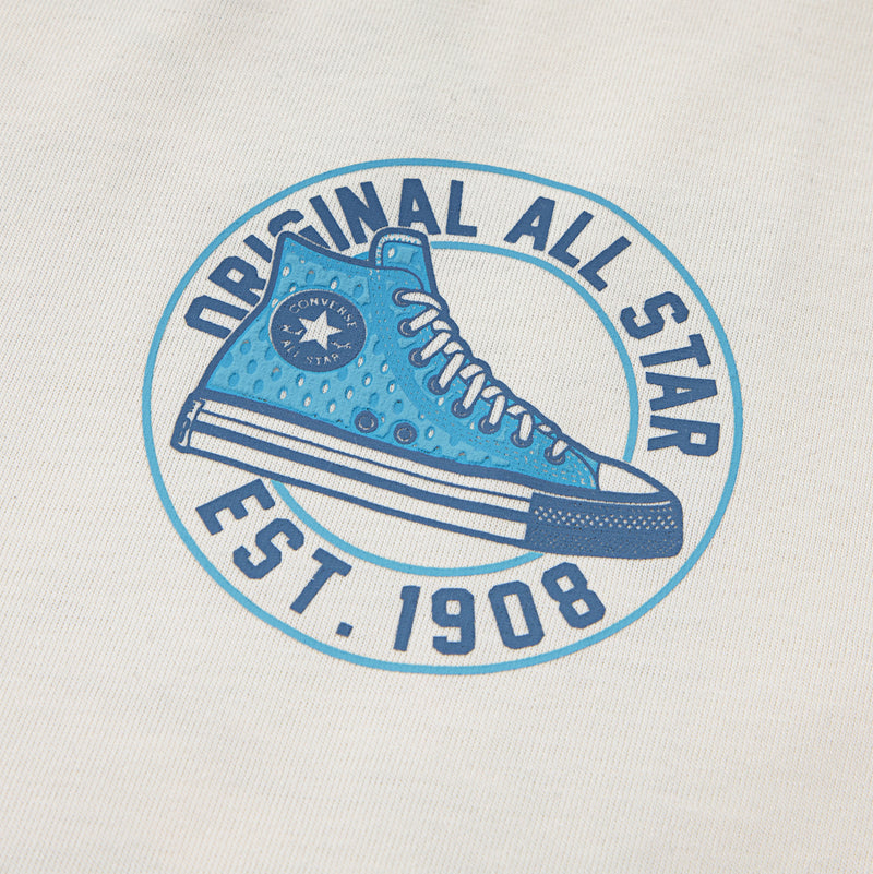 Close-up of blue Converse All Star circular logo printed on off-white T-shirt