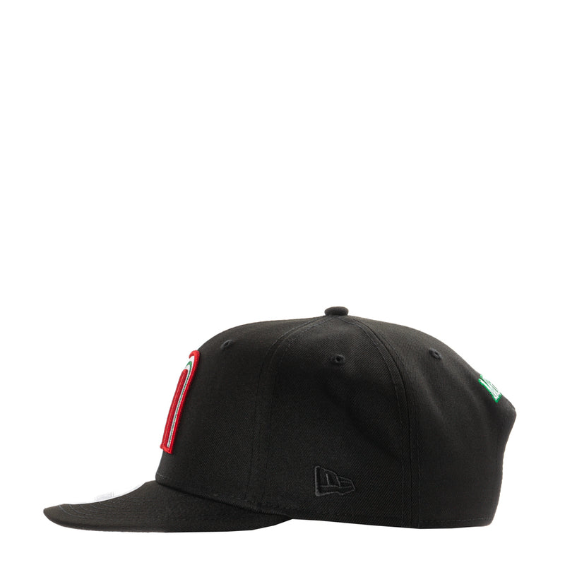 Black snapback cap with side embroidered red-and-green emblem and curved brim