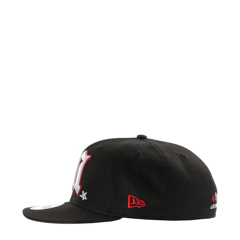 Black baseball cap with embroidered side patch featuring red star and flame detail