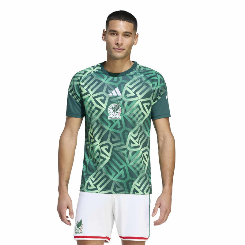 Men's green Mexico pre-match jersey on model, geometric pattern, V-neck and chest crest