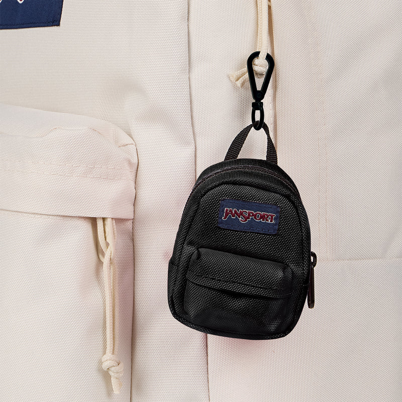 Black mini backpack close-up with Jansport logo patch and front zip pocket