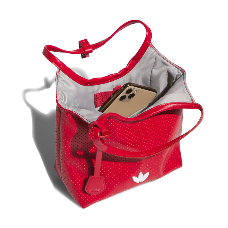 Mini perforated PU tote with red handles, grey lining and open top with phone inside