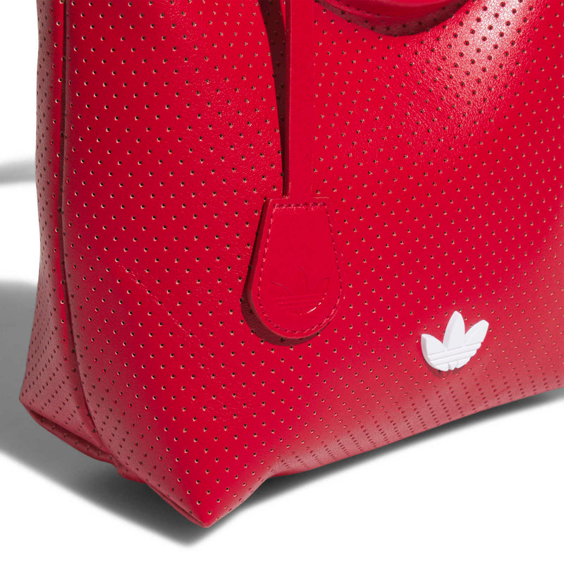 Mini perforated PU tote side with keychain tag, red strap tab and white trefoil logo