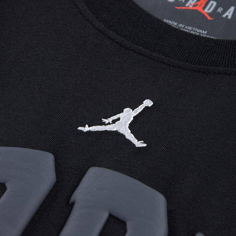 Youth black T-shirt with small white Jumpman logo near chest