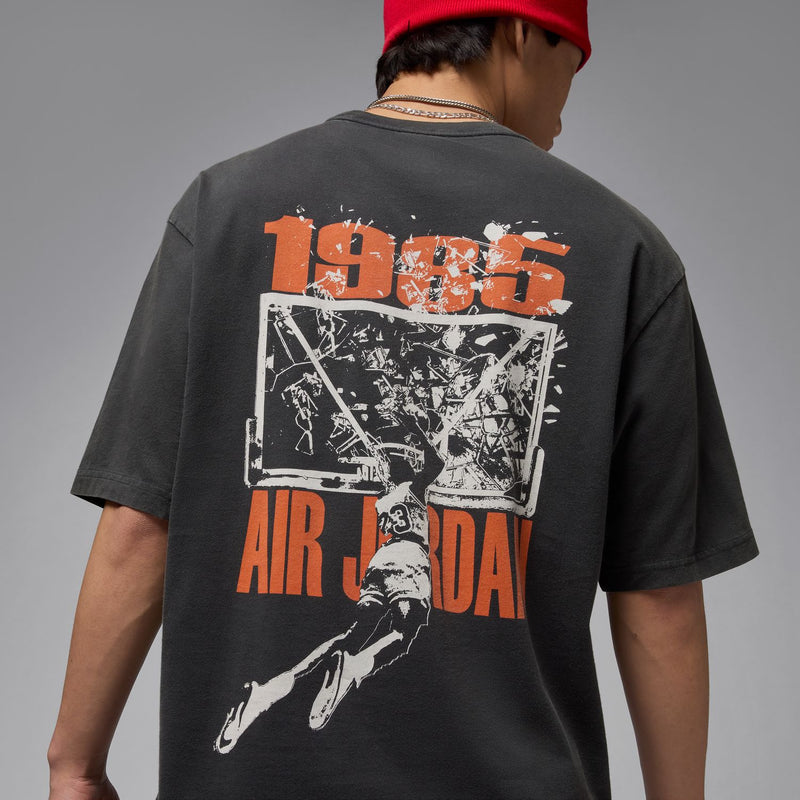 Black oversized crewneck T-shirt close-up of orange and white back graphic
