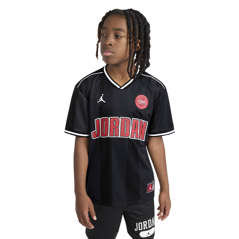 Black youth basketball jersey with V-neck trim and Jordan logos, worn by child