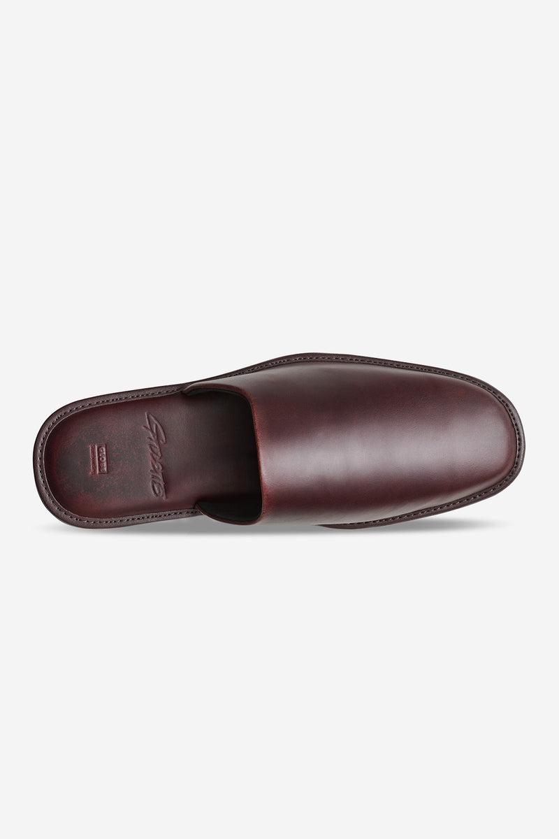 Top view of burgundy leather mule with clean stitching and an embossed brand on the insole.