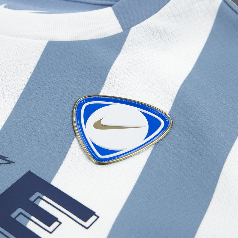 Light blue jersey logo badge with Nike mark on striped fabric