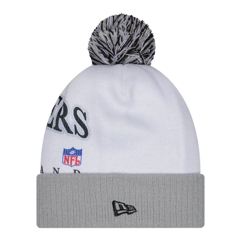 White knit beanie with gray cuff, Raiders side graphic and New Era flag, dark pom