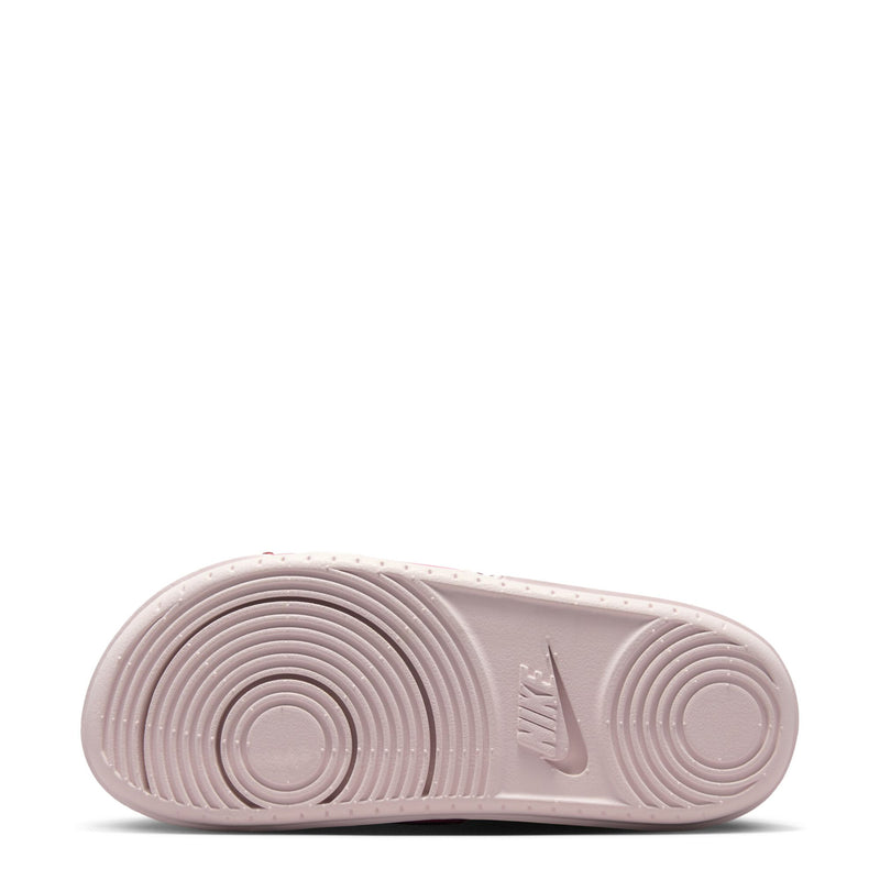 Slide sandal outsole, light pink rubber with circular tread and Nike mark