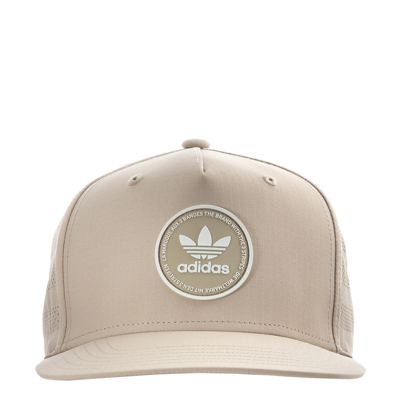 Light beige snapback cap with adidas circular emblem on the front.