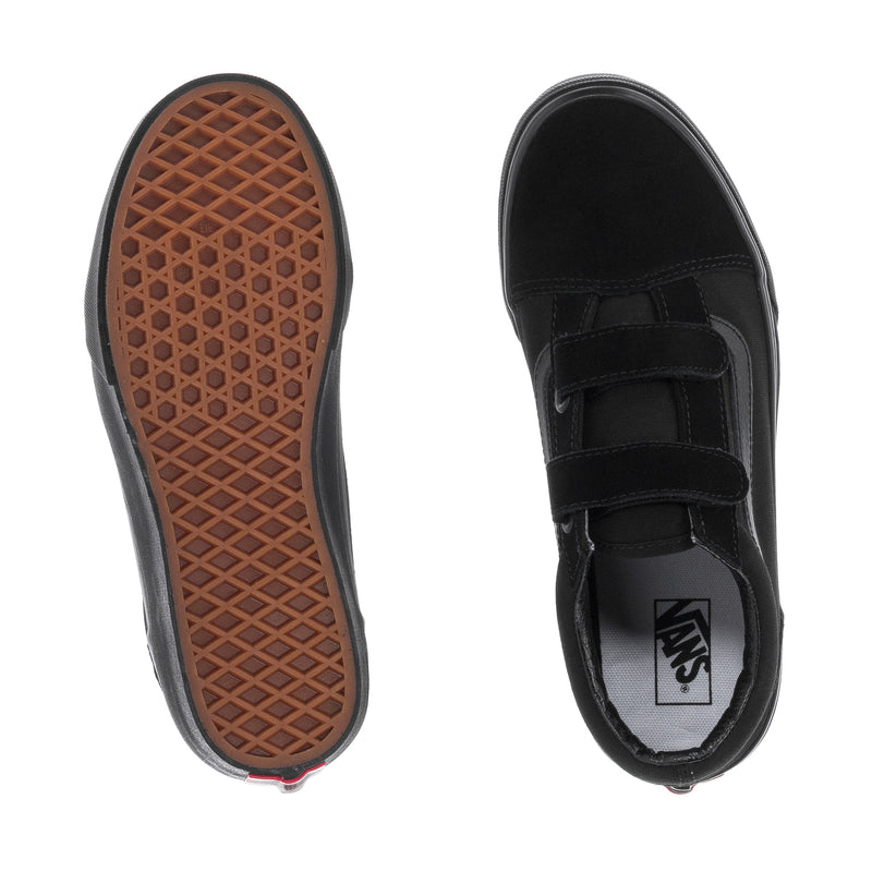 Black skate shoe with gum-pattern outsole tread and Vans logo on strap panel