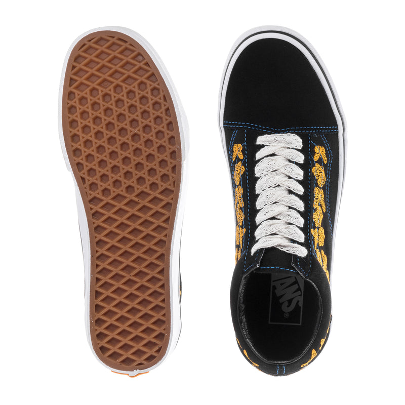 Women's sneakers outsole and heel view, black upper, white laces, gum tread sole