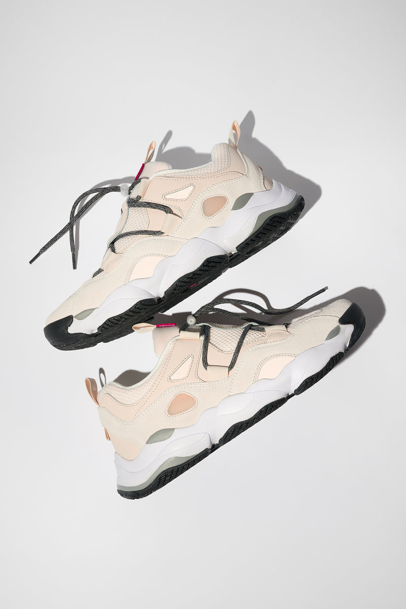 Angled top view of two Stone Vanilla Option Evo sneakers in light beige with layered panels