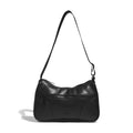 Black shoulder bag with wide strap, curved flap opening, and small front logo