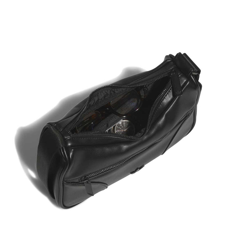 Black shoulder bag with zip-top opening, visible inner pocket, and metal hardware