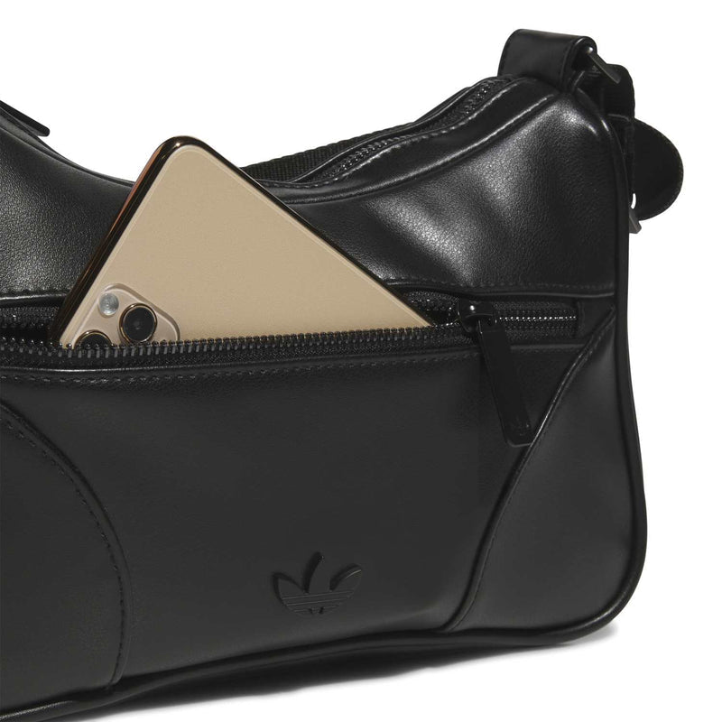 Black leather shoulder bag detail with tan insert panel and zippered interior