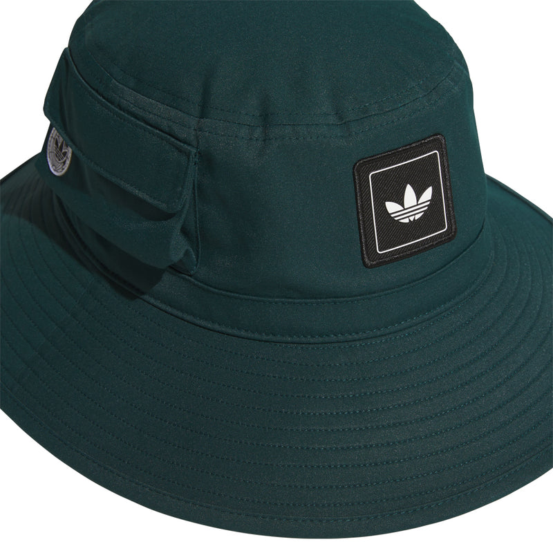 Dark green boonie hat with adidas trefoil logo patch, side close-up