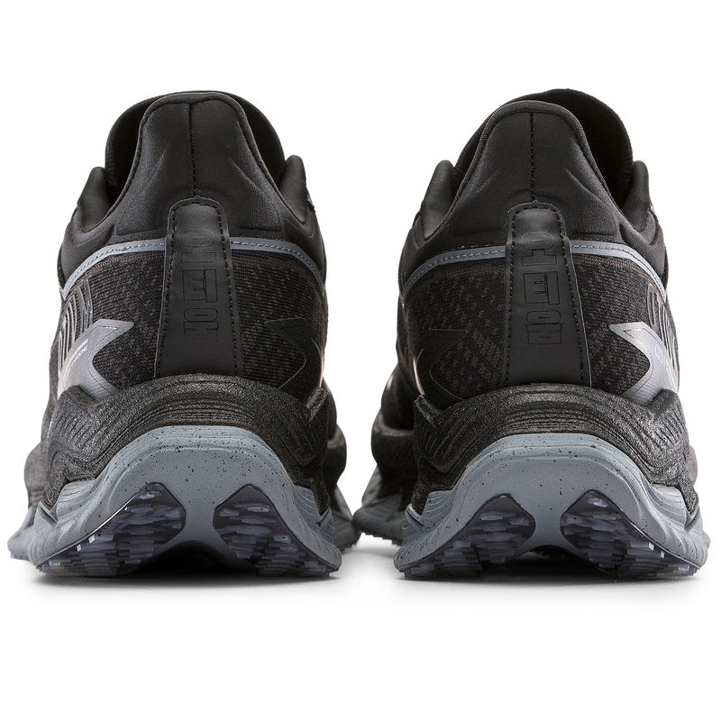 Black running shoes with visible sole design on a white background