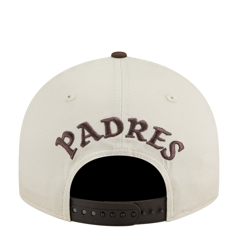 Cream Padres baseball cap back with 'PADRES' lettering and black snap strap