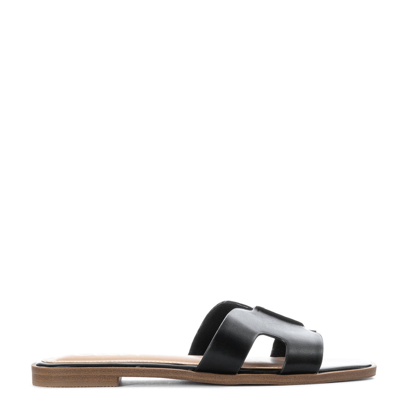 Women's black H-band slide sandals with wide strap and flat tan sole