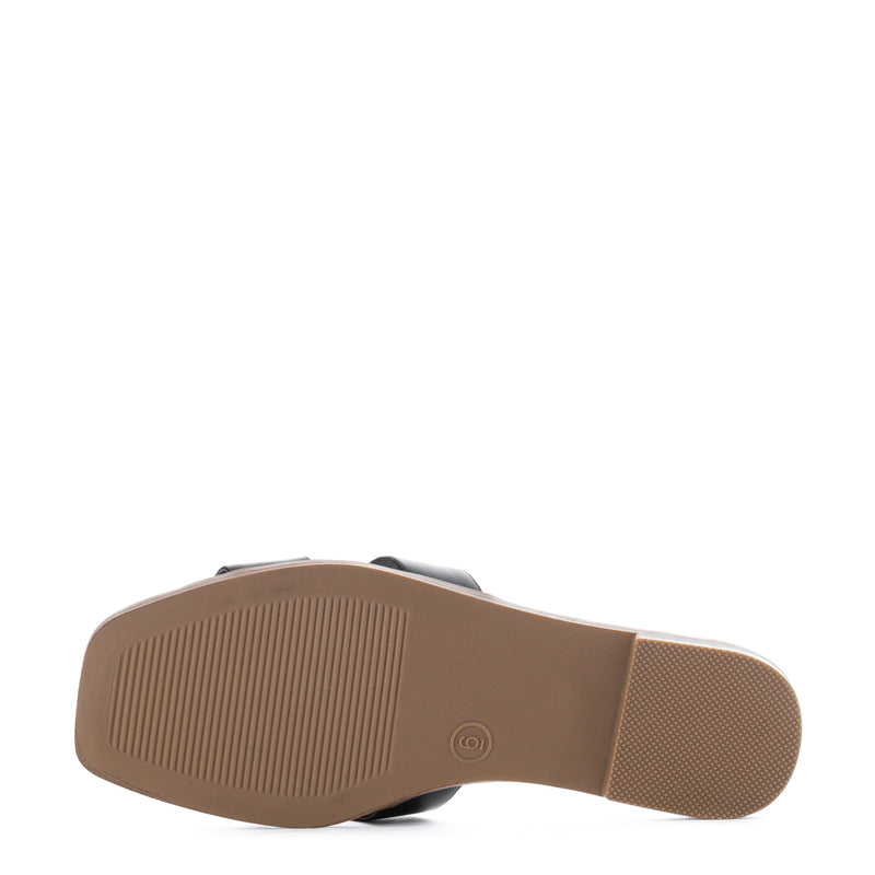 Women's black slide sandals outsole with textured tread, tan rubber sole