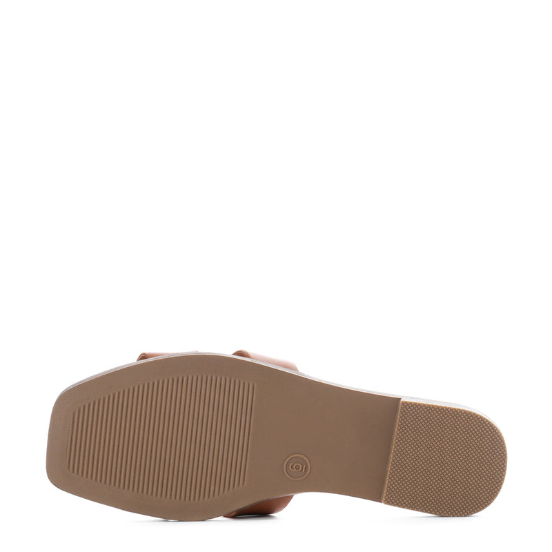 Cognac slide sandal outsole with textured tread and slip-resistant pad