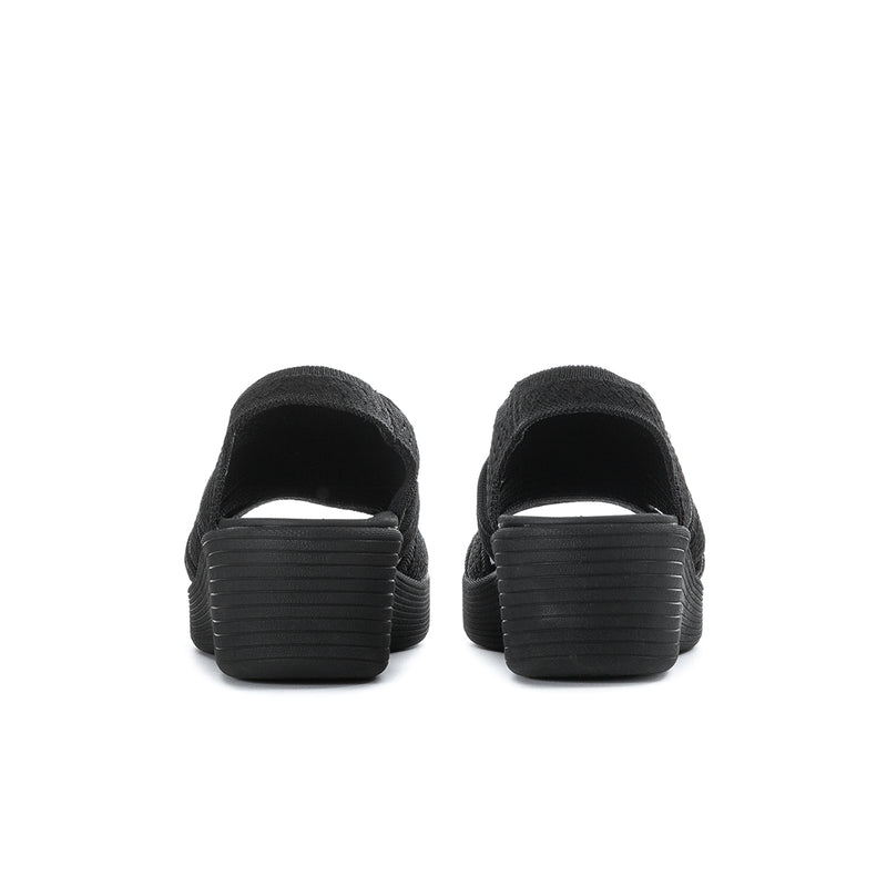 Black women's slingback platform sandals, rear view of heel and chunky ridged sole