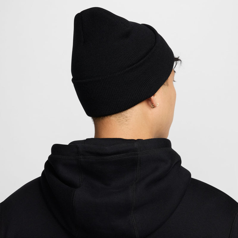 Black knit beanie with fold-up cuff, model back view