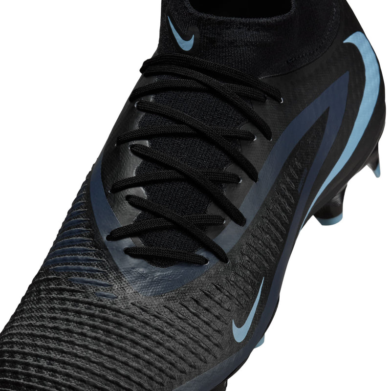 Close-up of black lace-up soccer cleat upper with light blue Nike logo